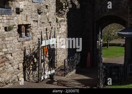 Inside The Gatehouse, Chepstow Castle, showing new iron gates decorated with medieval swords and crests. Stock Photo