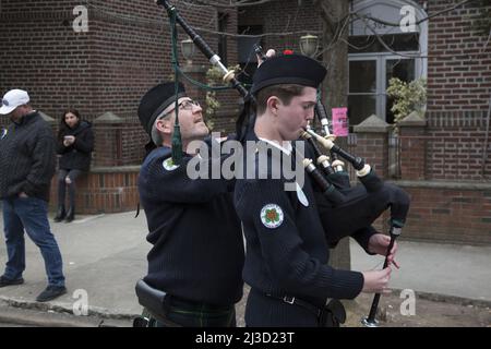 Xaverian High School Bagpipe musician getting his pipes tuned up before marching in the Saint Patrick's Day Parade in Bay Ridge, Brooklyn, New York. Stock Photo