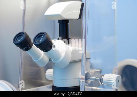 The eyepieces of a light or fluorescent microscope in a research laboratory environment Stock Photo