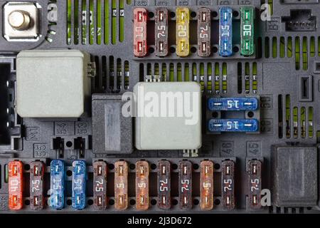 Plastic fuse box inside the engine compartment, visible fuses, relays ...