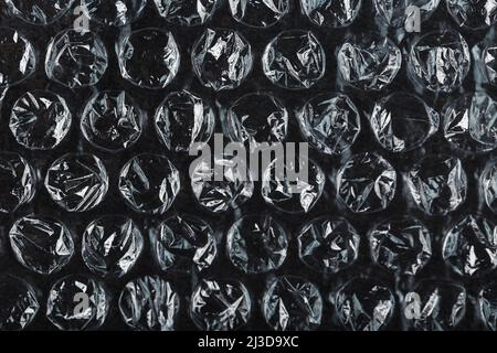 Packing bubble wrap for parcels on a Black background in full screen Stock Photo
