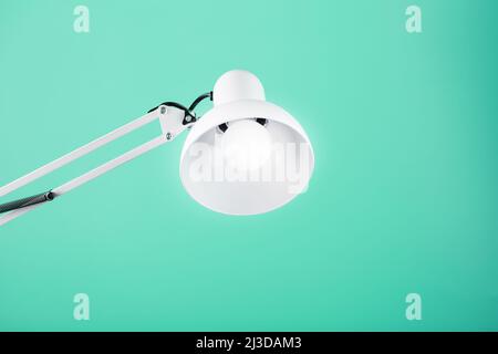 White table office lamp on green background with space for text and idea concept Stock Photo