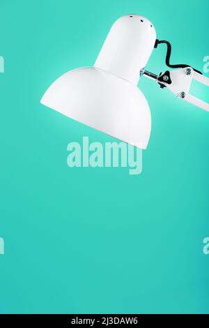 White table office lamp on green background with space for text and idea concept Stock Photo