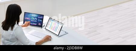 Analyst Employee Working With Spreadsheet Report On Laptop Screen Stock Photo