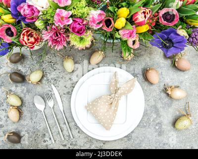 Easter table decoration with colorful spring flowers and eggs Stock Photo