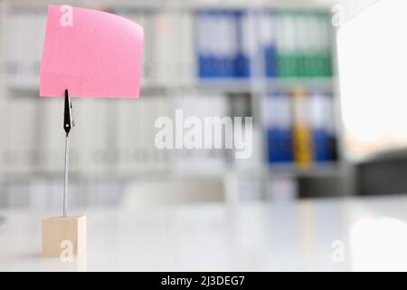 Pink blank note sticker on desk in office closeup Stock Photo