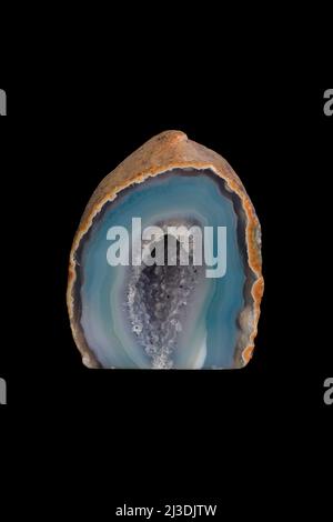 Hollow agate mineral, decorative stone on black background. Stock Photo