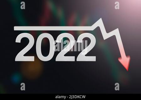 Crisis 2022. Quarterly or annual report of companies. Economic recession on the chart. Chart arrow pointing down against falling chart and dollar Stock Photo