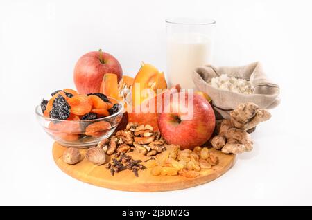 pumpkin and ingredients for pumpkin casserole with nuts and dried fruits on a light background Stock Photo