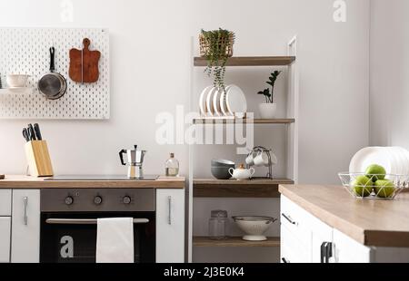 Modern shelving unit with tableware and counters in kitchen Stock Photo ...