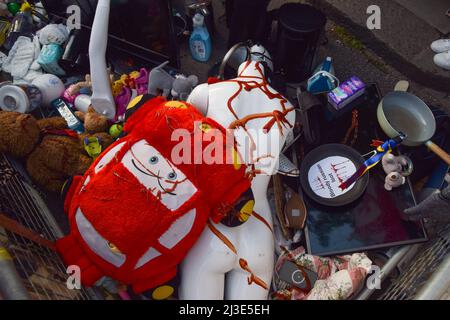 London, UK. 7th April 2022. Items covered in fake blood (ketchup). Hundreds of people gathered outside the Russian Embassy and dumped pans, clothing, toys, appliances and other household items, in response to the looting by Russian soldiers in Ukraine. Credit: Vuk Valcic/Alamy Live News Stock Photo
