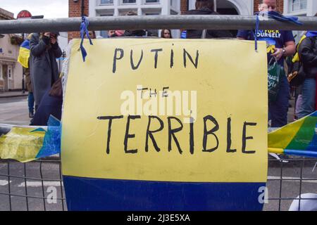 London, UK. 7th April 2022. 'Putin the Terrible' sign outside the embassy. Hundreds of people gathered outside the Russian Embassy and dumped pans, clothing, toys, appliances and other household items, in response to the looting by Russian soldiers in Ukraine. Credit: Vuk Valcic/Alamy Live News Stock Photo