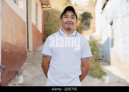 Latin man smiling outside his house in rural area - Hispanic man proud of his roots Stock Photo
