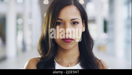 I take my business seriously. Cropped shot of a young beautiful businesswoman in a modern office. Stock Photo
