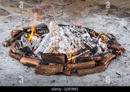 LARGE CIRCULAR BONFIRE BUILT ON THE GROUND. Stock Photo