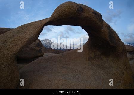 Beautifully scenic Easton Sierras from the Mobius arch in the Alabama Hills.  Mt Whiney in the background with it snow capped maintain range. Stock Photo