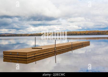 Floating wooden dock on Lac Taureau in autumn, Saint-Michel-des-Saints, Lanaudiere, Quebec, Canada. Stock Photo