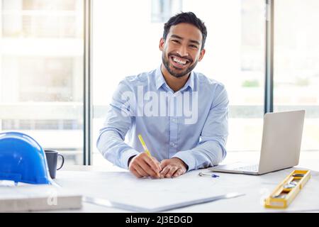 I can make these my own. Shot of a young male architect working in an office. Stock Photo