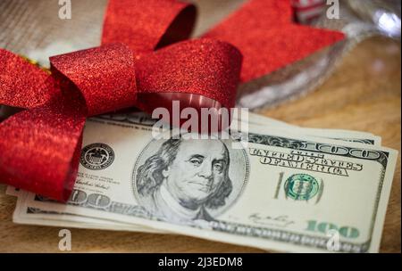 Who doesnt like money as a gift. Shot of money on a table during Christmas time. Stock Photo