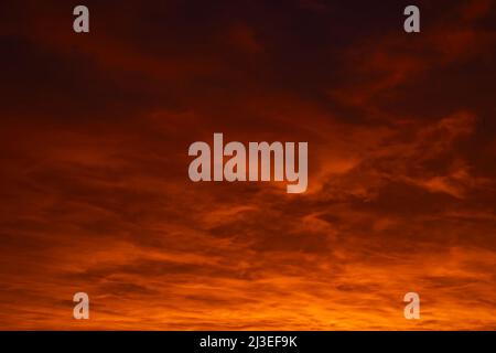 Cloudscape at sunrise or sunset. Orange clouds during sunset background photo. Dramatic cloudy sky at sunrise. Stock Photo
