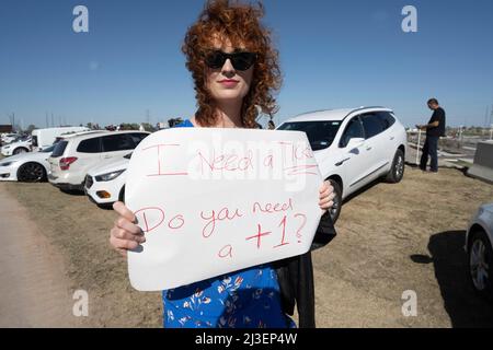 Austin Texas USA, April 7 2022: Bethany Bond of Austin looks for a ticket to get into the new Tesla Gigafactory Texas during its private grand opening event. The plant is the largest manufacturing facility in the U.S. and will gear up to turn out over 1,000 electric cars per day. Credit: Bob Daemmrich/Alamy Live News Stock Photo