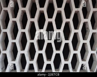 Cement plaster wall with decorative retro hole pattern Stock Photo