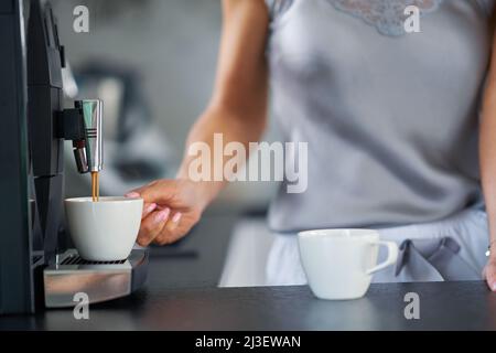 Nice woman making coffee in the kitchen Stock Photo