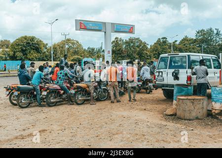 Jinka, Southern Nations Ethiopia - May 16, 2019: Young Ethiopian men, bikers, waiting at a gas station for refueling. City Jinka, Southern Nations Eth