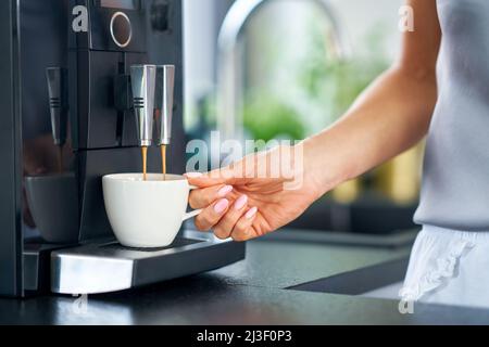 Nice woman making coffee in the kitchen Stock Photo