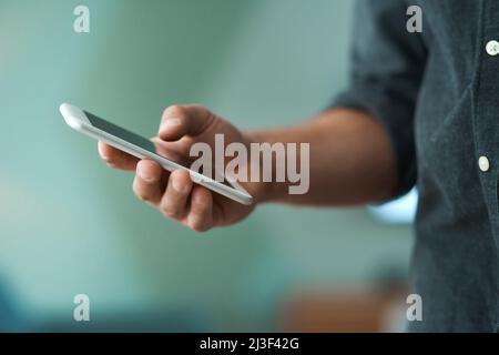 Having a phone can be so toxic sometimes. Shot of an unrecognizable man using a smartphone. Stock Photo