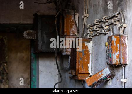 Old electrical cabinet with safety fuses and switches. Picture taken in soft, natural light. Stock Photo