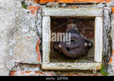 Old electrical on-off switch on the outside wall of the building. Picture taken in soft, natural light. Stock Photo