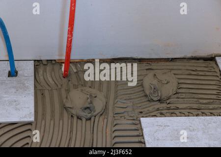 Worker Applying Tile Adhesive Glue On The Floor Stock Photo, Picture and  Royalty Free Image. Image 161102623.