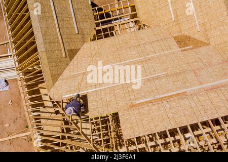 Builder on working a new roof in unfinished house Stock Photo