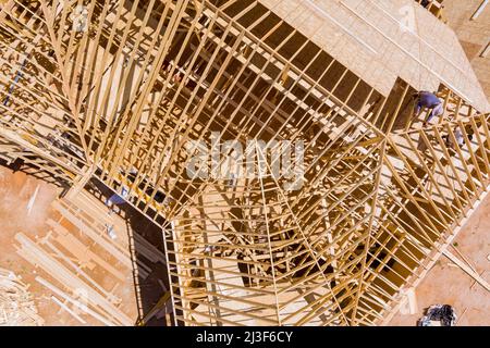 Roofer working on a new roof in wood Stock Photo