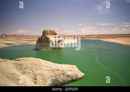 An aerial view of Lone Rock in Lake Powell, blue cloudy skies and green water. Arizona USA Stock Photo