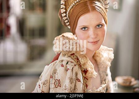 Noble beauty. Shot of an elegant noble woman in her palace room. Stock Photo