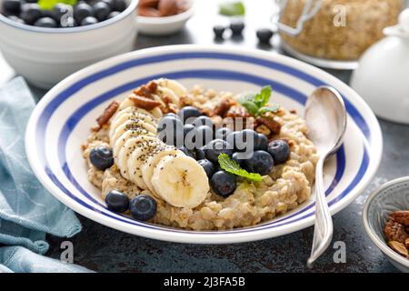 Oatmeal with fresh blueberries and pecans and banana Stock Photo