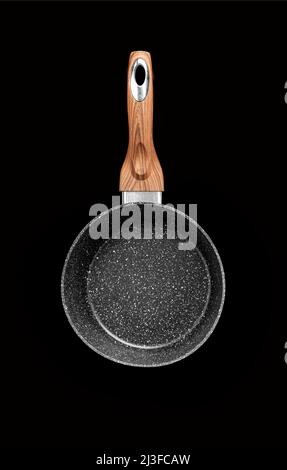 Modern frying pan with non-stick granite coating isolated on black background. With clipping path Stock Photo