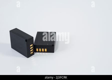 Lithium battery for digital photo cameras on isolated white background. Stock Photo