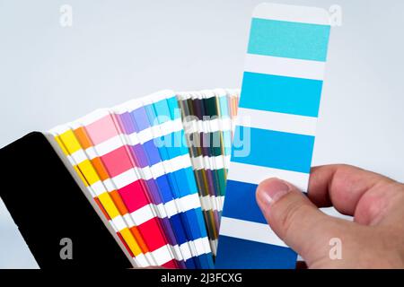 Color palette guide on white background. Close-Up Of Color Sample Against White Background. Stock Photo