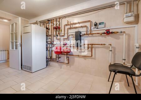 heating system in boiler room, gas and water supply system of house, measuring pressure and controlling temperature with sensors  for gas boiler with Stock Photo