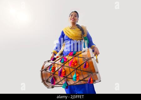 Portrait of Sikh woman playing drum during Baisakhi celebration Stock Photo