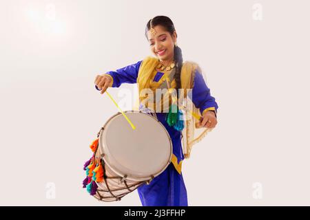 Portrait of Sikh woman playing drum during Baisakhi celebration Stock Photo