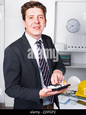 Young man worker calculating in the office on the computer Stock Photo