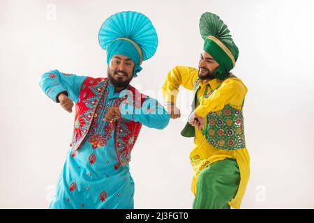 Sikh men performing bhangra together during Baisakhi celebration Stock Photo