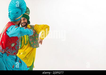 Sikh men performing bhangra together during Baisakhi celebration Stock Photo