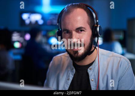 Portrait smiling looking at camera of a happy Stock Market Trader Working Investment Charts, Graphs. Financial Analyst and Digital Business man in a Stock Photo