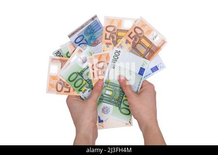 a bundle of euros of different denominations in the hands, isolated on a white background Stock Photo