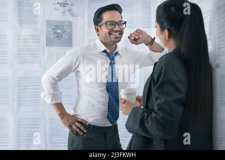 Happy business couple discussing regarding a new project in conference room Stock Photo